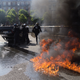 Image for article titled French taxi drivers rampage against Uber—burning tires, flipping cars, and inconveniencing Courtney Love